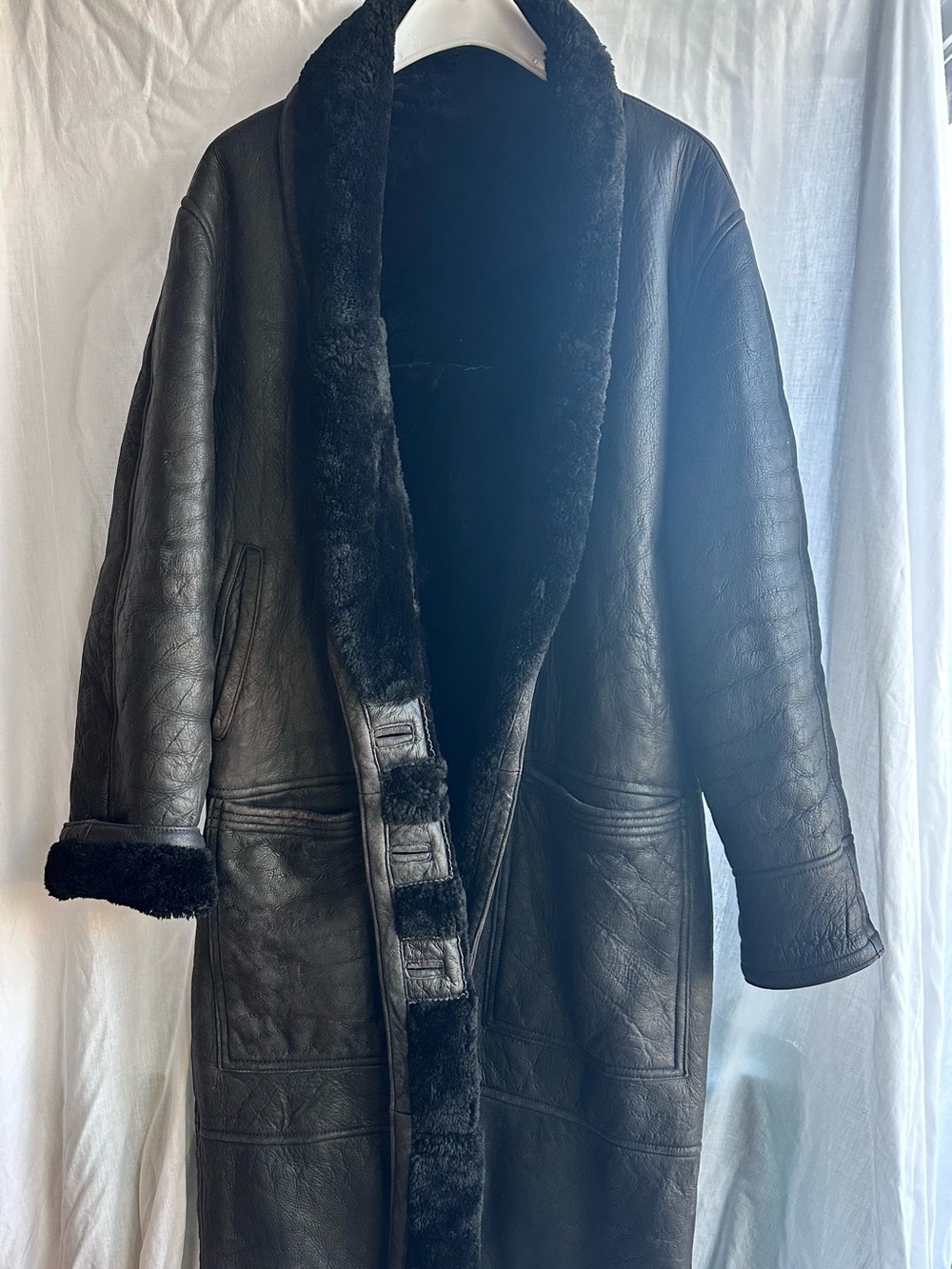 Full length black leather coat. Length from back collar to hem is 48inches.
